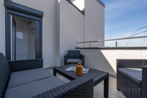 a patio with a table and chairs on a balcony at Vienna Stay Apartments Schönbrunn in Vienna