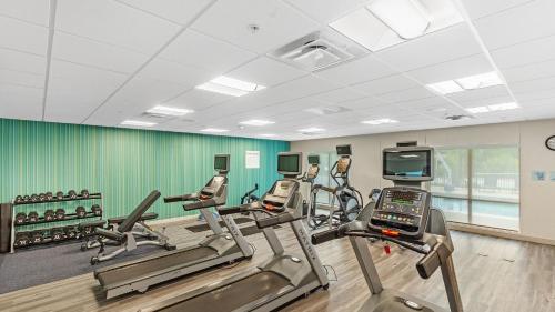 a gym with treadmills and cardio machines in a room at Holiday Inn Express & Suites Mobile - University Area by IHG in Mobile