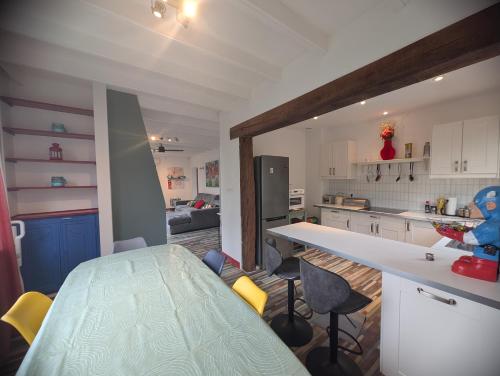 a kitchen with a counter and chairs in a room at Chemin des Vignerons in Metz