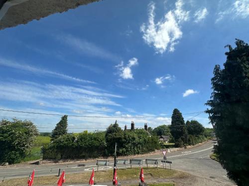 an empty road with flags on the side of the road at Norwood House in Newport