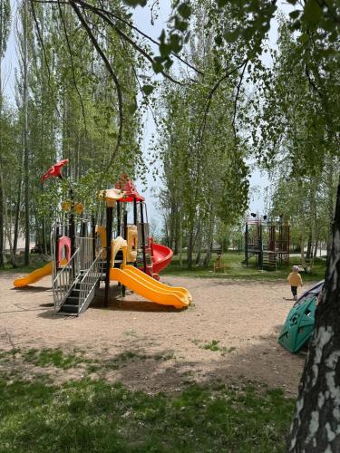 a playground with a slide in a park at A quiet harbor on Issyk Kule in Kodzhoyar