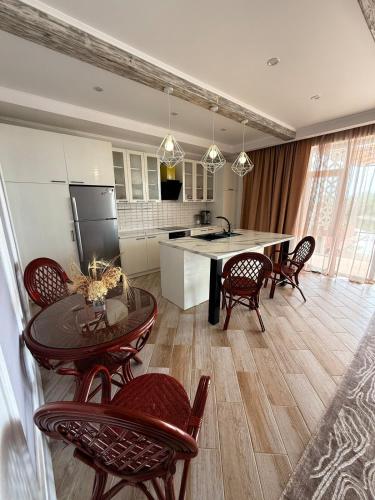 a kitchen and dining room with a table and chairs at A quiet harbor on Issyk Kule in Kodzhoyar