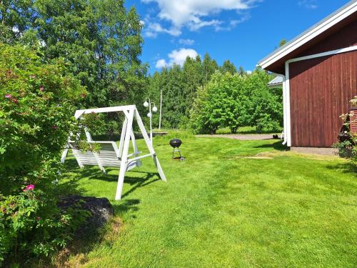 a white swing in a yard next to a building at Sunin Tupa in Rantsila