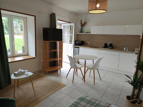 a kitchen with a table and chairs and a table at Studio équipé, proche aéroport in Bouguenais