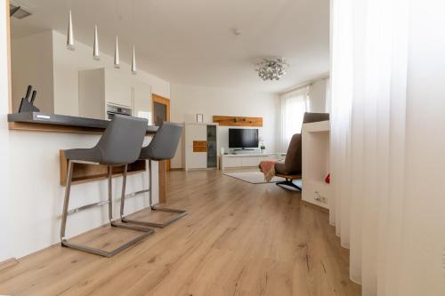 a living room with a table and two chairs at Apartment Klagenfurt Center with Free Parking - RING41 in Klagenfurt