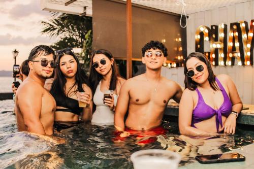 a group of people standing in a swimming pool at Hotel Petén Express in Flores
