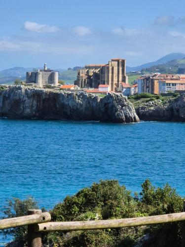 a view of a large body of water with buildings at Apto San Francisco,en el centro y en la playa in Castro-Urdiales