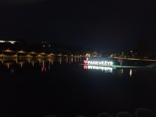 a boat on a body of water at night at ----------------------------- Via Baltica Panevezys in Panevėžys