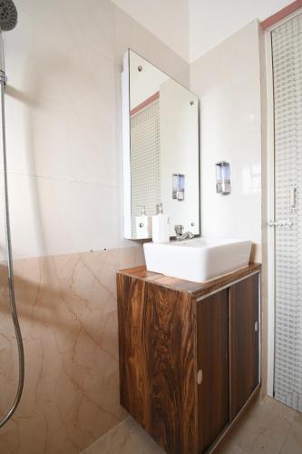 a bathroom with a sink and a mirror at Moon Guest House in Bhubaneshwar