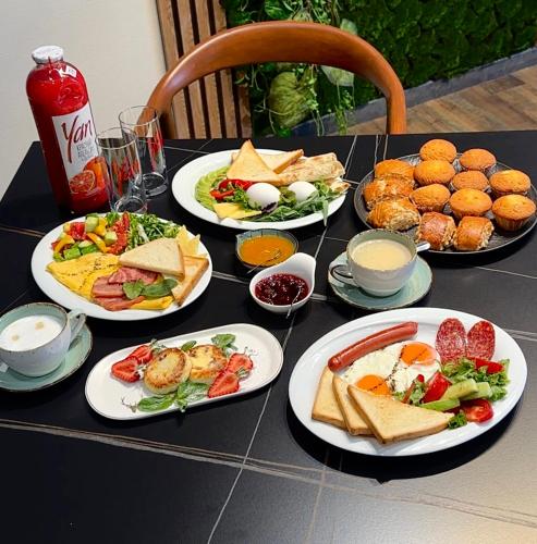 a black table with plates of food on it at Fidji Hotel in Yerevan
