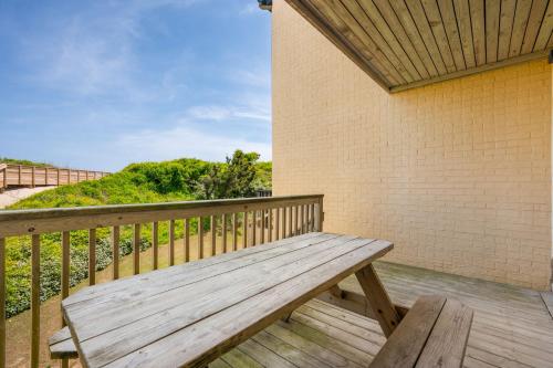 a wooden bench sitting on a deck with a wall at QA4 Coastal Comfort in Nags Head
