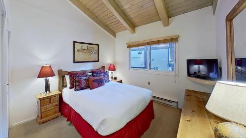 a bedroom with a large bed and a tv at Crestwood 3310 Standard 1 Bedroom Plus Loft in Snowmass Village