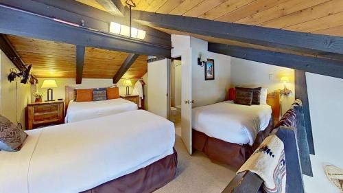 a bedroom with two beds in a room with wooden ceilings at Crestwood 3313 Deluxe 1 Bedroom Plus Loft in Snowmass Village