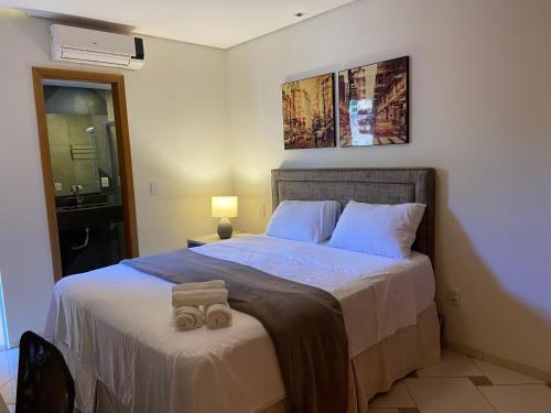 En eller flere senge i et værelse på Recevoir Garden Suítes