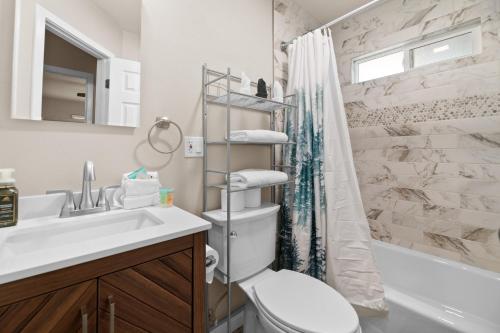 a bathroom with a sink and a toilet and a shower at The Maple Lane Hideaway - Hot Tub, Fireplace, Barbecue, Fenced Yard! in Sugarloaf