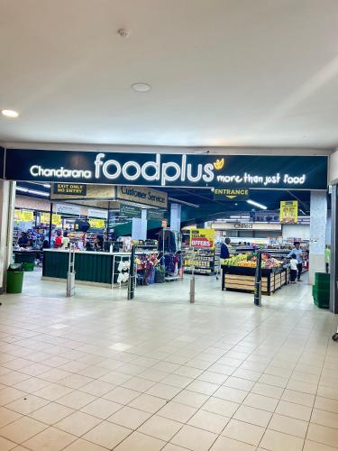 a grocery store aisle with a sign that reads fooditsu at Regal Suites in Athi River