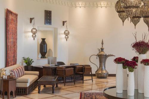 a living room with a couch and a table at Aldhafra Desert Resort, Vignette Collection by IHG in Madīnat Zāyid