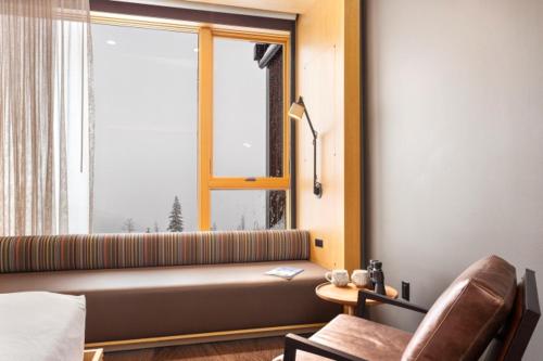 a living room with a couch and a window at Humbird Hotel in Sandpoint