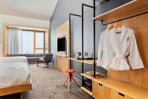 a hotel room with a bed and a white robe at Humbird Hotel in Sandpoint