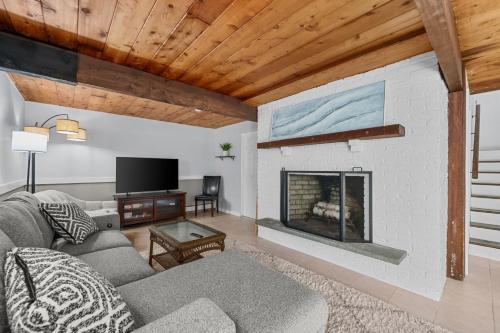 a living room with a couch and a fireplace at 10 Bunker Circle Sandwich - The Clubhouse Retreat in Sandwich