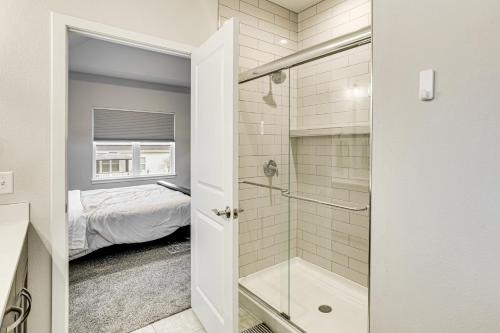 a bathroom with a walk in shower next to a bed at Spacious and Modern Home with Deck in Oregon! in Oregon