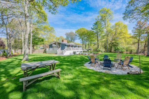 a backyard with a picnic table and chairs at 10 Bunker Circle Sandwich - The Clubhouse Retreat in Sandwich