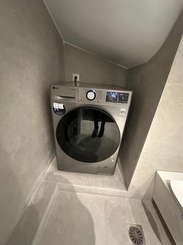 a washing machine in a corner of a bathroom at Artion Suites Nikiti in Nikiti