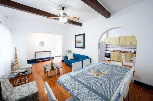 a living room with a bed and a blue couch at Casa Nutria - Pucusana Las Ninfas - Beach and Sea in Pucusana