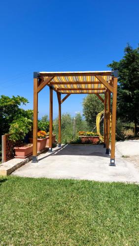 a wooden pavilion with a playground in a park at Villa Finocchito - The sound of silence in Ogliastro Cilento