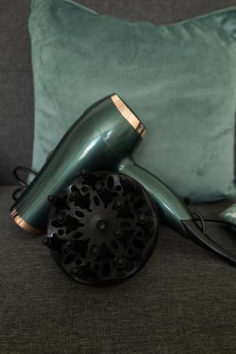 a green telephone sitting on top of a couch at The Trafford Luxe , Garage Parking, Self Check-in Anytime - Perfect for Late Arrivals, Ultra- Fast Wi-Fi, 5 mins to Old Trafford Stadium in Manchester