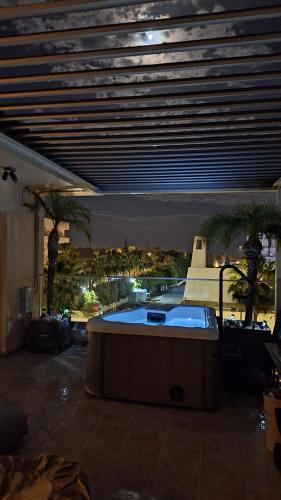 a building with a hot tub with a view of a city at Nissi Golden Sands Paradi in Ayia Napa