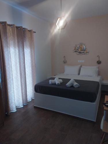 a bedroom with a bed with two towels on it at Vitali sea house III in Vitálion