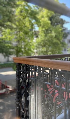 a fence with a wooden table on top of it at Maison Martin 7 in Kortrijk