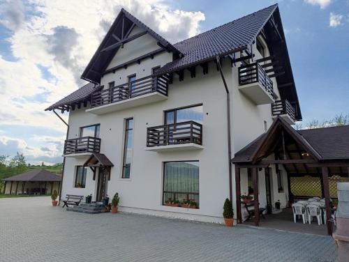 a white house with a black roof at Vila President Sovata in Sovata