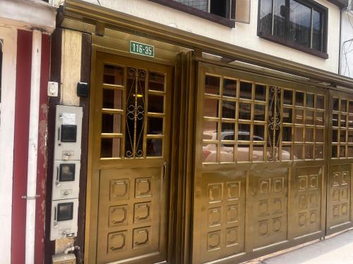 a pair of doors on a building with a sign on it at Apartamento a 10 minutos del aeropuerto de Bogotá in Bogotá
