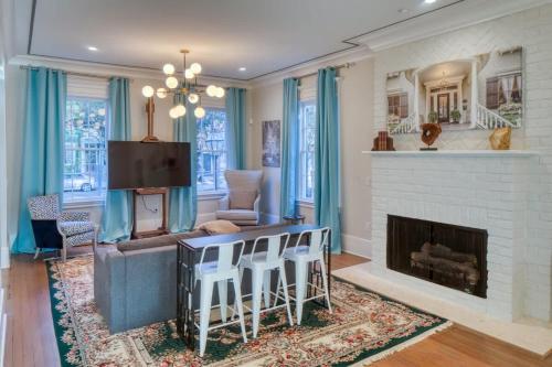 a living room with a couch and a fireplace at Luxury Villa 3 BR w Private Bath Walk Everywhere in Savannah