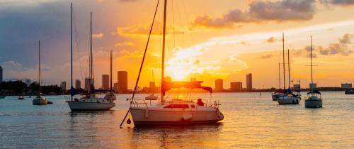 a group of boats in the water at sunset at Kimpton Angler’s Hotel South Beach by IHG in Miami Beach