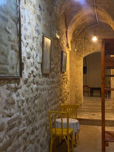 a dining room with a table and yellow chairs at Traditional Medina House - Entire Home in Tunis