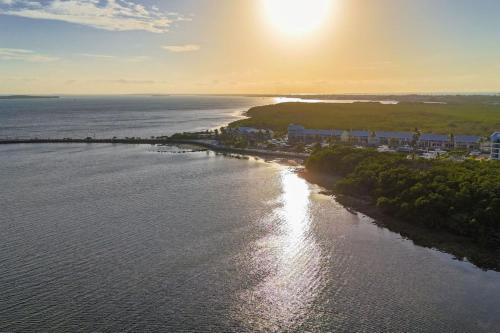 an aerial view of a beach with the sun setting at KAWAMA J3 in Key Largo, Beach, Lagoon, Pools, Tennis, Free Bikes and Canoes in Key Largo