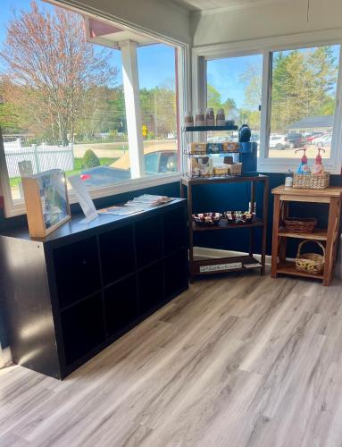 a room with wooden floors and a counter with windows at Saco River Motor Lodge & Suites in Center Conway