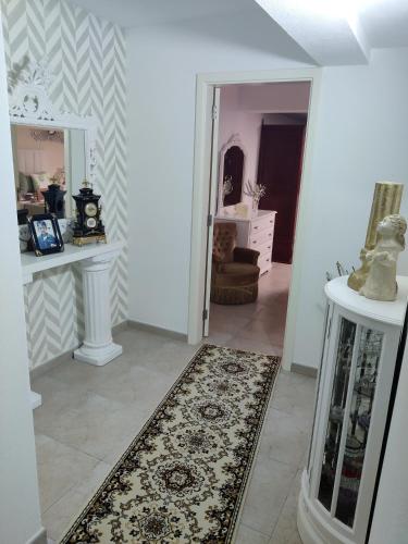 a room with a hallway with a rug on the floor at HOUSEMARIA in Nazaré