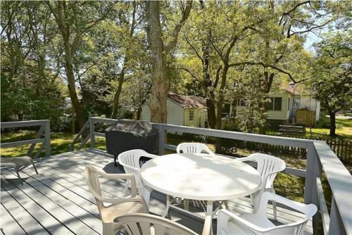 a white table and chairs on a deck at Relaxing Beginnings in Cape May Point