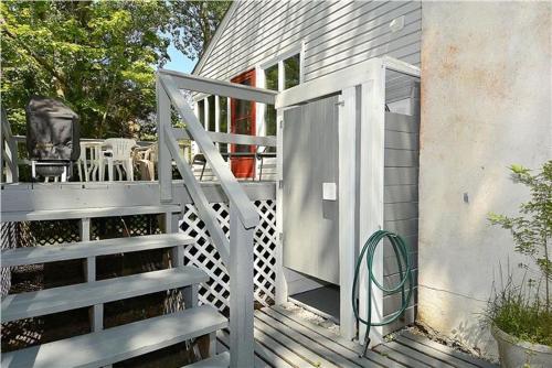 a wooden staircase leading to a house with a porch at Relaxing Beginnings in Cape May Point