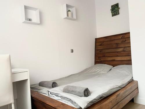 a bedroom with a bed with a wooden headboard at City Center in Szeged