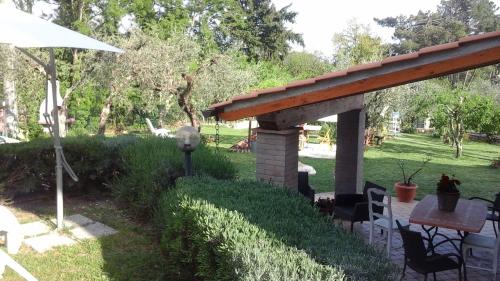 a pavilion with a table and chairs in a yard at Penelope in Marliana