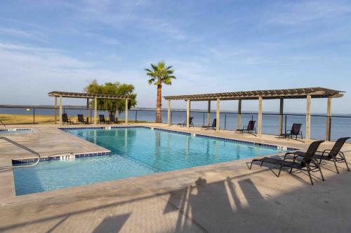 a swimming pool with chairs and a view of the ocean at On The Lake #117 in Onalaska