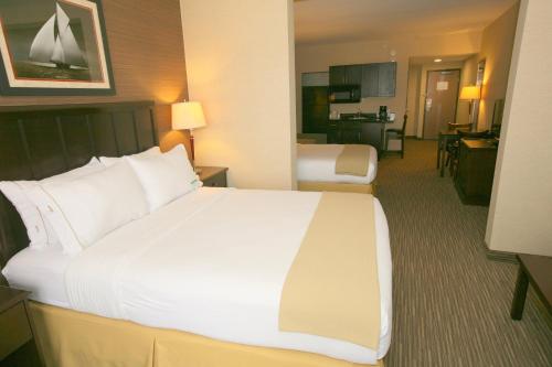 a large white bed in a hotel room at Holiday Inn Express San Diego South - Chula Vista by IHG in Chula Vista