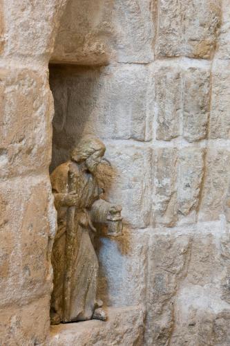 a statue of a man on the side of a wall at La Maison des Augustins 4 stars Spa et Fitness in Avignon