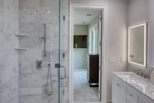 a bathroom with a shower with a glass door at Luxurious Key Largo Oceanfront 3 Bed 3 5 Bath suite in Jewfish