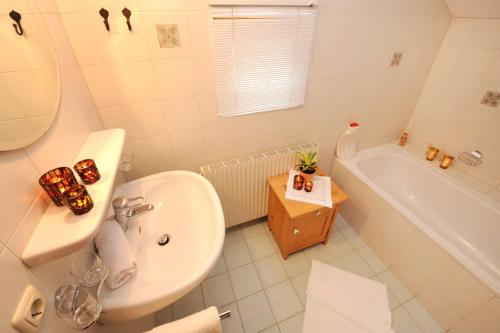 a bathroom with a sink and a toilet and a tub at Ruhige Wohnung In Sankt Gallenkirch Mit Garten in Sankt Gallenkirch